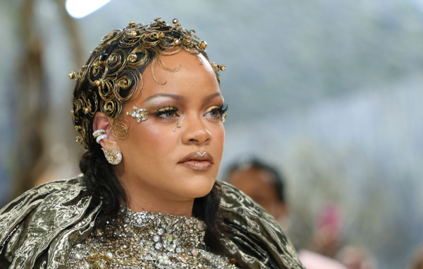 Rihanna wears gold makeup to the Met Gala.
